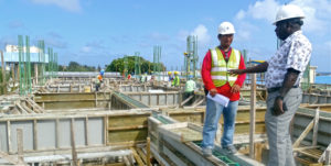 PNA CEO Ludwig Kumoru talks to PII Foreman Alexfil Barba on what will become the third floor of the PNA headquarters. Photo: Hilary Hosia.
