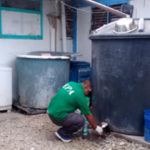 An EPA official takes a water sample from a catchment tank on Ebeye for laboratory testing.