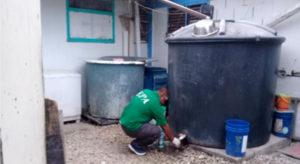 An EPA official takes a water sample from a catchment tank on Ebeye for laboratory testing.
