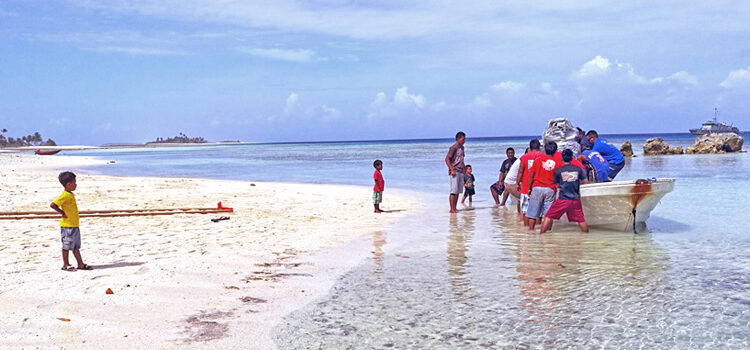AMI and Aur residents off-load an airplane engine from a small boat that was then carried up the beach and loaded onto a pickup truck for delivery to the waiting Dornier aircraft. AMI performs engine change on Aur Atoll