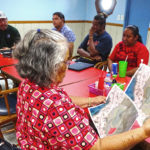 Jenrok landowners reviewed plans for an Olympic-standard track field to be built on the ocean side reef between the Marshall Islands Club and Marshall Islands High School — with the dual purpose of buffering the area against frequent ocean inundations. The group met with, top from left, Minister Tony Muller, PII Manager Bobby Muller, and RMI Project Management Unit Director Melvin Dacillo. Photo: Hilary Hosia.