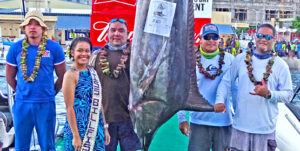 Captain Damien Milne, second from right, and his team fishing on Bakaro caught this 330 pound marlin on day one of the two-day Marshalls Billfish Club annual fishing tournament. The second day he caught the tournament-winning 415 pound marlin. Photo: Hilary Hosia.