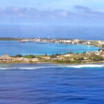 An aerial view of Kwajalein Island, headquarters of the US Army Garrison — Kwajalein Atoll. Reef fish in various areas of this island have been heavily contaminated by arsenic and PCBs from the Army’s landfill and harbor industrial vessel operations. Photo: Giff Johnson.