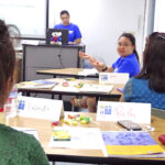 Marshall Islands Epidemiology and Prevention Initiatives (MIEPI) staff members Molly Murphy (at podium) and Maybelline Ipil (facing camera, right) present during the recent mental health responders training program at CMI. Photo: Hilary Hosia.
