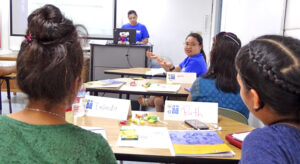 Marshall Islands Epidemiology and Prevention Initiatives (MIEPI) staff members Molly Murphy (at podium) and Maybelline Ipil (facing camera, right) present during the recent mental health responders training program at CMI. Photo: Hilary Hosia.