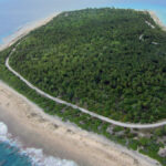 An aerial photo of Rongelap Island shows the road paved as part of clean up efforts in the early 2000s. New studies say that Naen Island in the northern part of the atoll is seriously contaminated with radiation, indicating it and other northern islands would need to be cleaned before a resettlement happens. Photo: Giff Johnson.