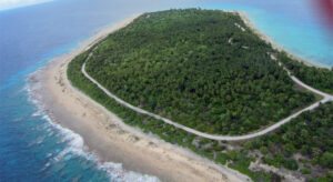 An aerial photo of Rongelap Island shows the road paved as part of clean up efforts in the early 2000s. New studies say that Naen Island in the northern part of the atoll is seriously contaminated with radiation, indicating it and other northern islands would need to be cleaned before a resettlement happens. Photo: Giff Johnson.
