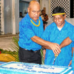 Newly ordained deacons Deacons Maise Myazoe, Stephen Lepton, and Ekpap Silk, Jr. cut the cake at a celebration by Assumption Parish of the historic event. Photo: Daisy Alik-Momotaro.