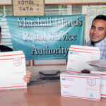 Post Office staff Cheryl Muller and Rommy Kaneko show off the newly arrived express and priority flat rate boxes, envelopes, tape and labels.