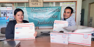 Post Office staff Cheryl Muller and Rommy Kaneko show off the newly arrived express and priority flat rate boxes, envelopes, tape and labels.