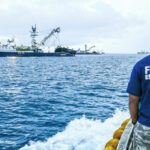 A Marshall Islands Marine Resources Authority Fisheries Enforcement Officer heads out to check a purse seiner in Majuro’s lagoon prior to start of tuna transshipment operations. Photo: Francisco Blaha.