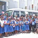 Grateful Assumption students and staff pose with Japan Ambassador Norio Saito and the new bus. Photo: Hilary Hosia.