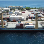 A view of Majuro’s Delap Dock, the facility that handles container vessels such as this Matson ship. Local businesses say the 14-day Covid-19 quarantine requirement for ships is delaying arrival of vessels and causing significant losses to local companies. Photo: Tyler Milne.