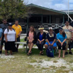 A team from the Ministry of Natural Resources and Commerce/Office of Commerce, Investment and Tourism and the Marshall Islands Resort visited Likiep Atoll in June to meet with Mayor Nicholas deBrum and local officials concerning reviving the Likiep Plantation Haus hotel. They are pictured in front of the Likiep hotel.