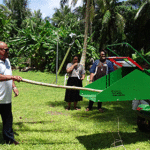 Majuro Mayor Ladie Jack tries out the new wood chipper by giving it a tree branch to turn into mulch during a gathering with the Ministry of Natural Resources and Commerce and Laura Farmers Association last weekend. Photo: Eve Burns.