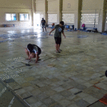 Marshall Islands Volleyball Federation players work on improving the playing surface of the SDA gym in Delap by installing floor tiles. Photo: Eve Burns.