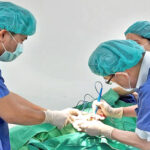 Dr. David Alfred, left, assists with a surgery at Shuang-ho Hospital in Taiwan. He was the first Marshallese to graduate from medical school in Taiwan.