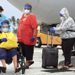 First Lady Ginger Kabua (third from right) with mother Dolores Shoniber (in wheelchair) and niece Natalie Shoniber were the first to get off Saturday’s United Airlines flight at Kwajalein as the first group of repatriated Marshallese arrived. Photo: RMI Liaison Office.