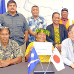 At the grant ceremony at the Japan Embassy, from left: Public School System Commissioner Kanchi Hosia, DES Principal Loretta Case, and Japan Ambassador Norio Saito surrounded by PS staff. Photo: Eve Burns.