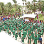 A view of the graduates minutes after the ceremony ended and as they prepared to perform a stylish dance for the thousands of friends and family members who turned out for the graduation. Photo: Wilmer Joel.