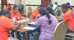 At the International Conference Center Saturday night, August 21, Electoral Administration staff started tabulation of votes cast in the special election to fill mayor and council seats. Photo: Wilmer Joel