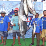 Team KBE, captained by KBE Executive Councilman Nixon Jibas, took second place in the marlin contest with this 166 pounder, and second place in the tuna competition, with a 46 pound yellowfin. Miss All Micronesia Debby Schutz is pictured with Team KBE. Photo: Wilmer Joel.