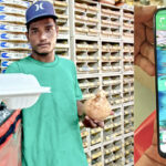 Wiahut delivery man Carlon Reiher delivers a lunch to customers at the Majuro Net Yard recently.