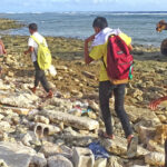 MIHS students want to go to school as demonstrated by these boys who were not deterred by the front gate being locked Tuesday shortly after 8am — they headed to the ocean side reef to get into the campus and to class. Photo: Wilmer Joel.