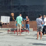 Marshall Islands Police Department CID detectives Captain Vincent Tani (back to camera) and Lt. Carney Terry check and photograph the body of an I-Kiribati fisherman found in the water next to Delap Dock Tuesday morning.