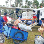 Local residents of Majkin, Namu join with passengers in loading and unloading the flight this week. Photo: Hilary Hosia.