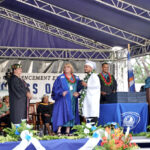 CMI President Dr. Irene Taafaki, center, presided over the diploma ceremony at the May 26 graduation. She was joined, at left by Vice President for Academic and Student Affairs Dr. Elizabeth Switaj Board of Regents Chairperson Kathryn Relang, and Mikaa Reiher behind the stacks of diplomas. Photo: CMI Media Office.