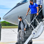 US Special Presidential Envoy for Compact Negotiations Ambassador Joseph Yun is greeted by US Ambassador to RMI Roxanne Cabral at Bucholz Army Airfield following his arrival Tuesday this week at Kwajalein. A saluting Marine airman and Deputy Assistant Secretary of Interior Keone Nakoa are also pictured. Photo: US Army/Jessica Dambruch.