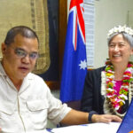 After signing an agreement for the exchange of programs between Australian Broadcasting Corporation and the RMI government’s V7AB AM radio station, Australian Foreign Minister Penny Wong looked on as Minister Ota Kisino flicked the switch on a radio to turn on the first broadcast of an ABC program on V7AB in six years. Photo: Hilary Hosia.