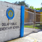 The padlocked gate at Delap Elementary School, shut down by landowners who are waiting to get paid. As a result, the school is several weeks late in opening. Photo: Hilary Hosia.