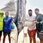 Braving the pouring rain April 1, Team Hangloose, with Captain Larry Hernandez, Jr. (second from left), poses with the 390 pound marlin they caught during the Marshalls Billfish Club’s fishing tournament.