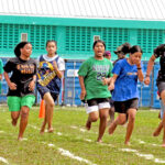 Working out during the recent Sports Day at Marshall Islands High School, sprinters head to the finish line. Photo: Wilmer Joel.