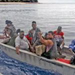 A small boat offloads goods from a government-chartered Pacific International Inc. vessel carrying fuel and food to Kili earlier this week.