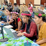 Students, journalists and public information officers who participated in last week’s Media and Democracy Workshops in Majuro also attended the Summit on Democracy June 22 at the ICC to report on the presentations. Working on their story to meet a deadline while at the Summit is one of the workshop teams, from right: Lita Flood, Jamrianna White, Kalah Wannie Anjolok, and Olya Pedro. Photo: Giff Johnson.