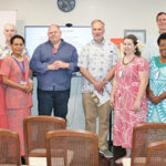 US Embassy Chargé Henry Hand, fifth from right, led an Asia Foundation-provided book donation to three schools and the Alele Library last month.