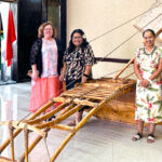 Marshallese Educational Initiative team from Springdale posing next to a canoe at the International Conference Center in Majuro. From left Board Member Dr. Lori Dean, Program Manager Marcina Langrine, Program Director Carlnis Jerry, and Executive Director Benetick Kabua Maddison.