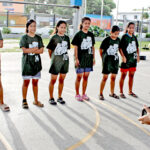 CMI student Pijja Matauto films Marshall Islands High School girls basketball players for an introduction video he will produce. Photo: Wilmer Joel