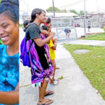 Left, Jacklyn Alex and Marynold Toston enjoy an item they found on the internet. Right, A group of girls from Rita create a short video for the popular app TikTok. Photos: Wilmer Joel.