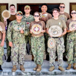 The US Navy’s Pacific Partnership medical team that visited Our Atoll to assist the Ministry of Health and Human Services in TB eradication shows off the handicrafts received from the community for their several day visit.
