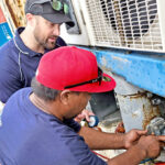 FAO-provided refrigeration expert worked with local technicians during a freezer container maintenance training in Majuro in early December. Photo: Sergio Bolasina.