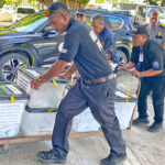 Police deliver the boxes with the postal absentee ballots from the RMI post office in Uliga to the ICC tabulation headquarters Monday morning. Photo: Hilary Hosia.