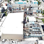 A drone photo shows the two old power plants in Majuro, foreground center. Poorly functioning and non-functioning engines well beyond their useful lifespans are still in service in Majuro, causing instability in power service to the capital. Photo: Tyler Milne.