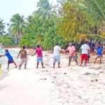 A fire-brigade line offloads relief aid for an island in Arno Atoll earlier this week following wave damage on January 20. Photo: Red Cross.