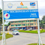 A Micronesian Games sign went up along Amata Kabua Blvd. in Majuro last week, reminding everyone that the games are coming up in less than four months. Communications improvements are in the works to fix glitches in the cell system to ensure that the anticipated 1,500 incoming athletes, coaches and officials will adequate phone service. Photo: Eve Burns.
