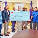 Taiwan Ambassador Steve Hsia, center, presented the donation to RMI Finance Minister David Paul, left of check poster. Also in attendance were Arno Nitijela Member Gerald Zackios, and Ailinglaplap representatives Vice Speaker Isaac Zackhras and Bruce Loeak.