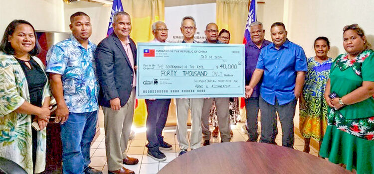 Taiwan Ambassador Steve Hsia, center, presented the donation to RMI Finance Minister David Paul, left of check poster. Also in attendance were Arno Nitijela Member Gerald Zackios, and Ailinglaplap representatives Vice Speaker Isaac Zackhras and Bruce Loeak. Taiwan helps wave victims